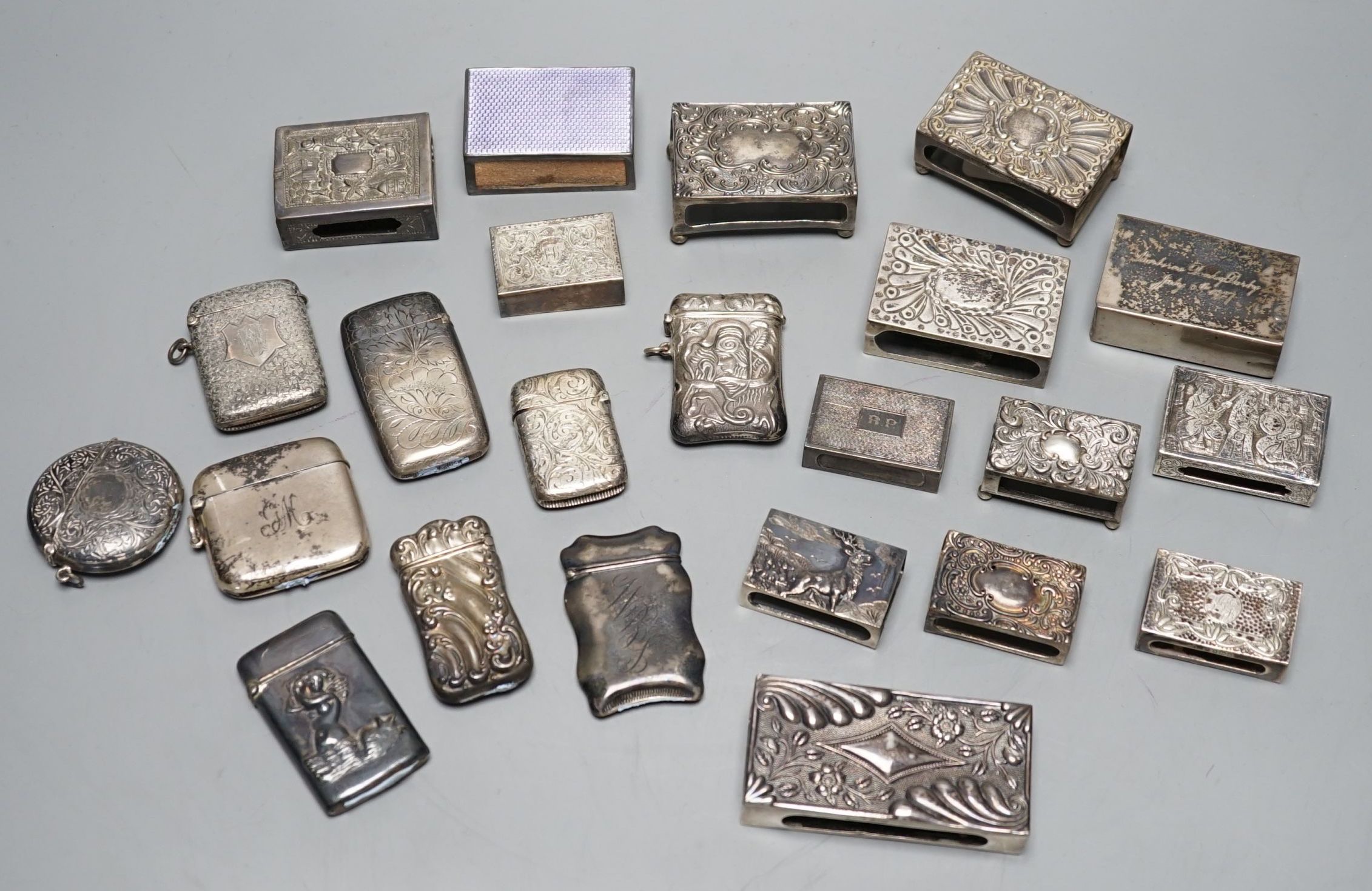 A small collection of nine mainly early 20th century silver or sterling vesta cases, largest 60mm and fourteen assorted similar silver or white metal match sleeves